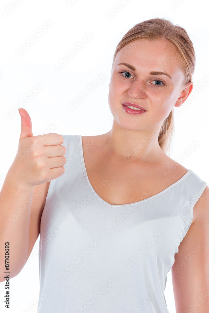 Portrait of a young happy girl after fitness showing thumb isolated on white background Portrait of a young happy girl after fitness showing thumb isolated on white background