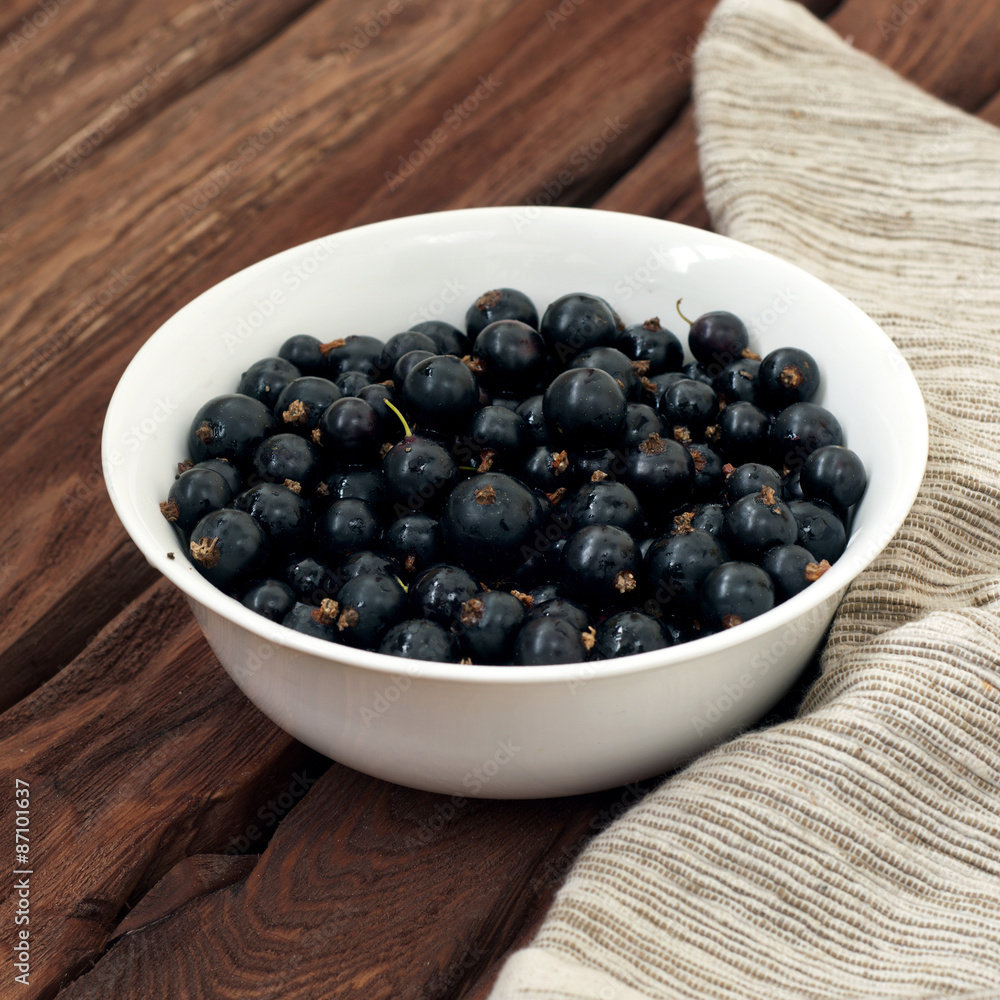 Honeysuckle berries in a deep ceramic bowl on a wooden background. Fresh ripe blueberries. Top view with copy space for text Honeysuckle berries in a deep ceramic bowl on a wooden background. Fresh ripe blueberries. Top view with copy space for text