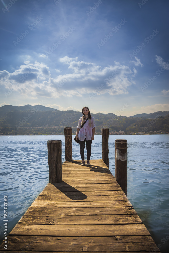 Woman standing on a wooden pier