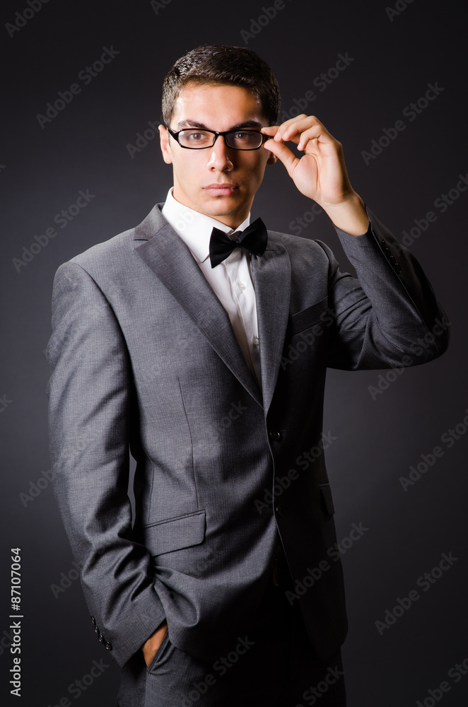 Young elegant man against gray Young elegant man against gray