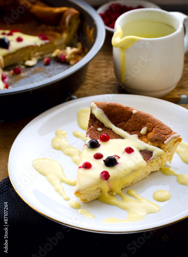 pudding with frozen berries and vanilla sauce