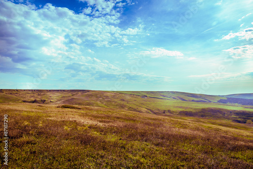 bright sunrise above the hills and meadows with clouds