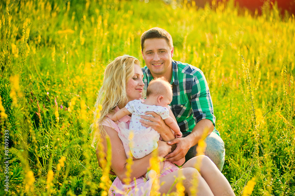 happy young family spending time outdoor on a summer day happy young family spending time outdoor on a summer day
