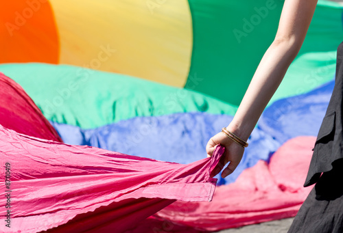 Woman s hand taking rainbow peace flag