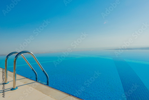 Infinity pool on the bright summer day