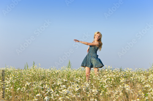 The happy young woman in the field  of camomiles © Konstantin Kulikov