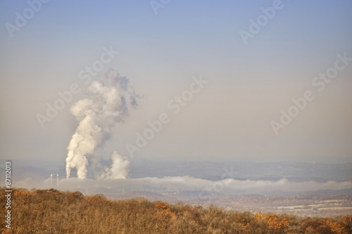 Coal burning plumes over rural landscape