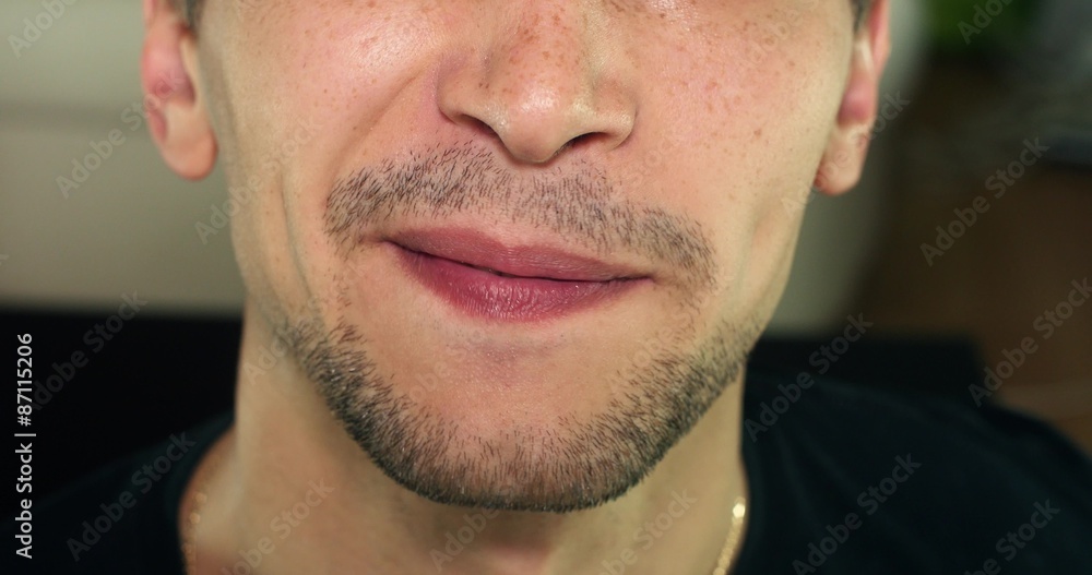 Unshaven man smiling, grimacing, clean between the teeth Unshaven man smiling, grimacing, clean between the teeth