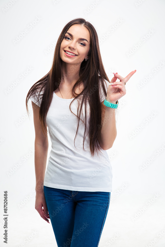 Smiling woman pointing finger away Smiling woman pointing finger away
