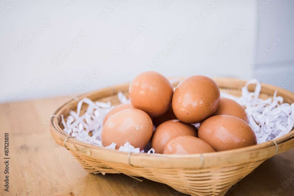 Brown eggs in a wicker basket on a wooden table Brown eggs in a wicker basket on a wooden table