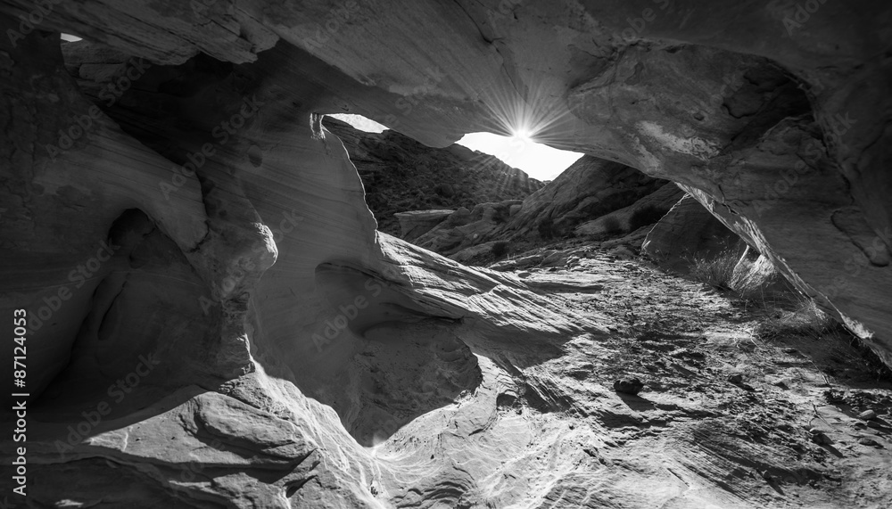 Sun peeking from behind the arch Black and White Abstract Rock F
