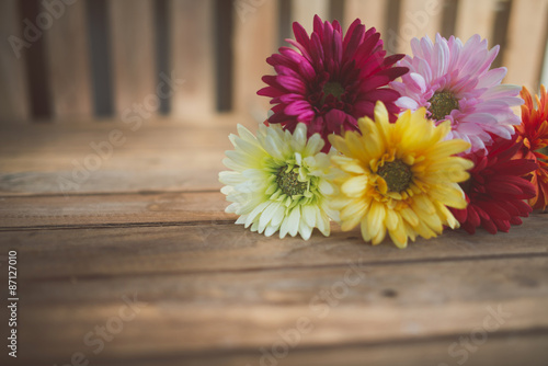 gerbera flowers (artificial ) on wood background