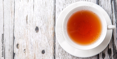 A cup of tea over weathered wooden background