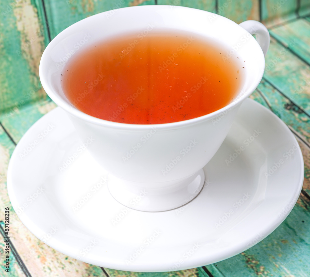 A cup of tea over weathered wooden background A cup of tea over weathered wooden background