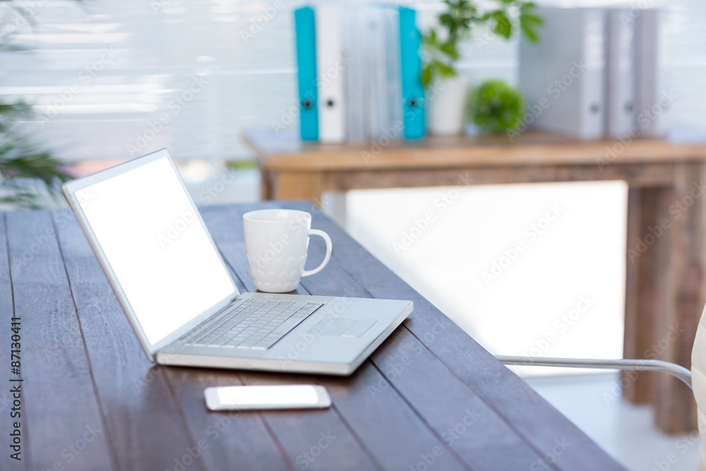 Business desk with laptop and smartphone Business desk with laptop and smartphone