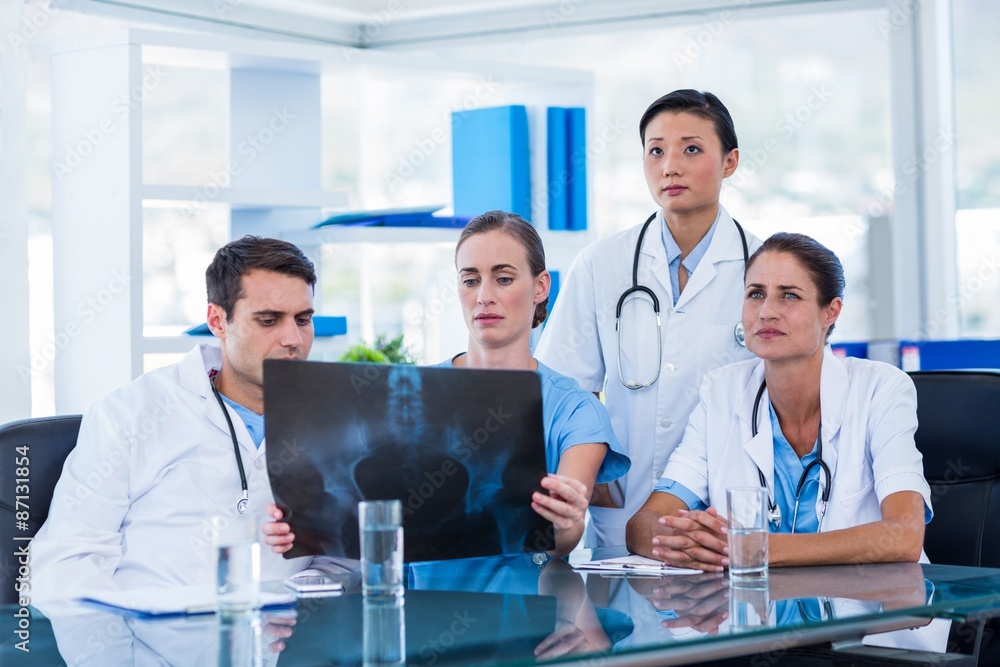 Team of doctors looking at xray