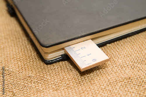 Notepads and wooden ruler on the old tissue