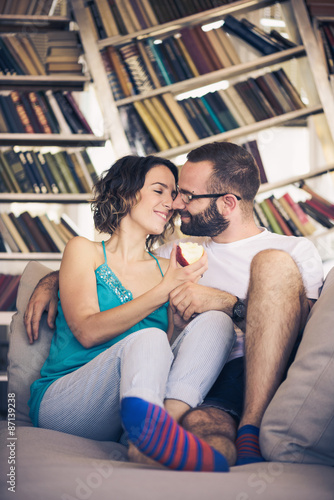 Young romantic couple sitting on sofa 