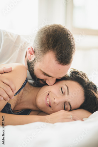 Young man and woman in bed