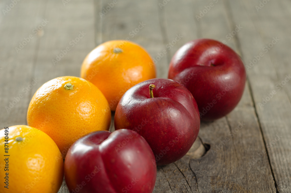 Plums and Clementines on Table Plums and Clementines on Table