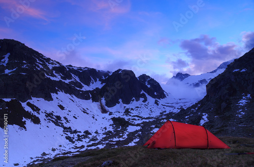 Tent at a mountain campsite in the Alps during an beautiful evening.