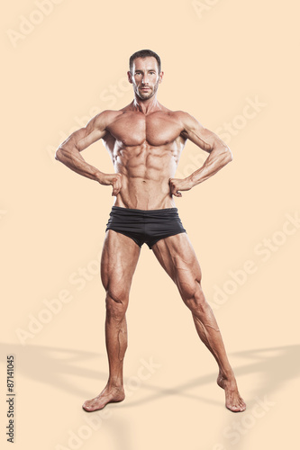 Obraz na plátně muscle man, bodybuilding athlete full body portrait