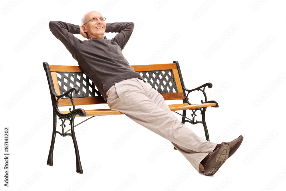Carefree senior sitting comfortably on a bench Carefree senior sitting comfortably on a bench