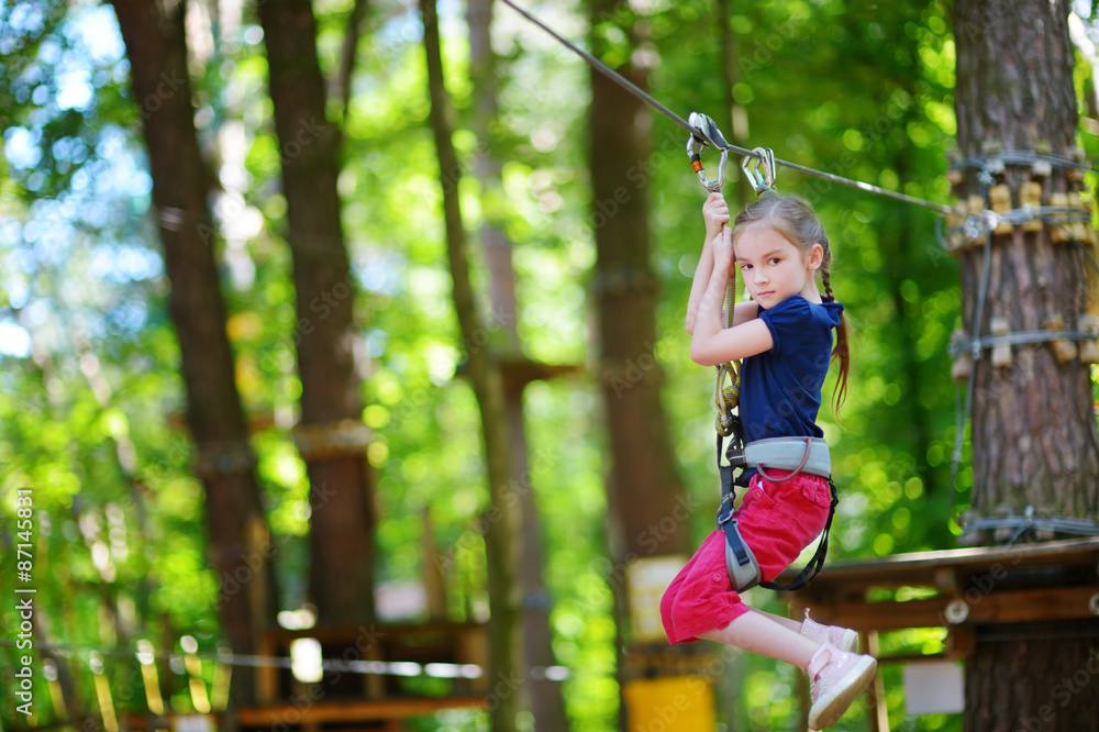 Little girl enjoying her time in adventure park