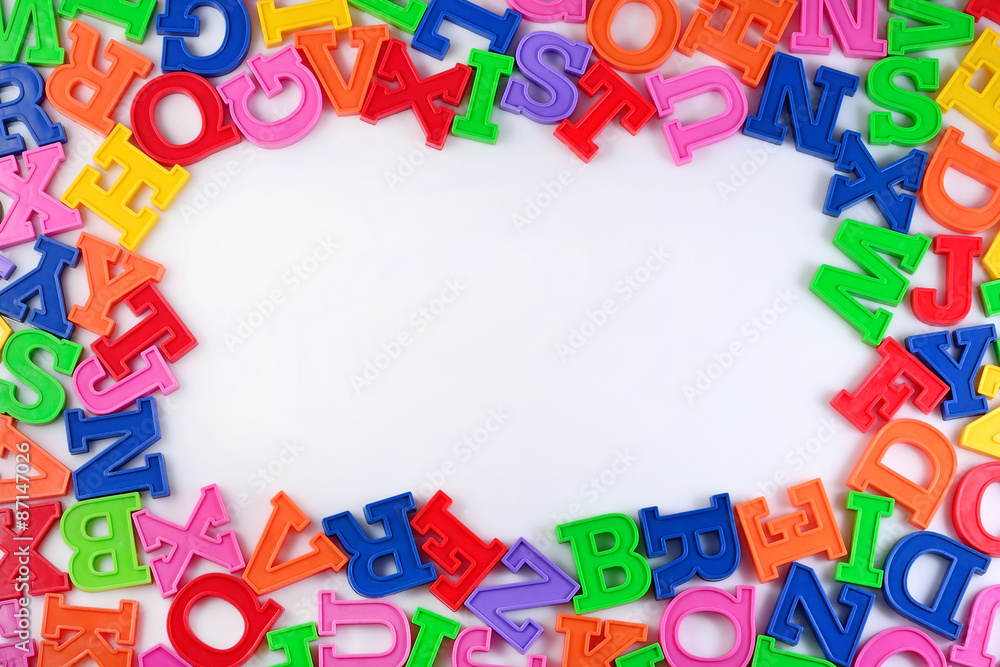 Frame of plastic colorful alphabet letters on a white