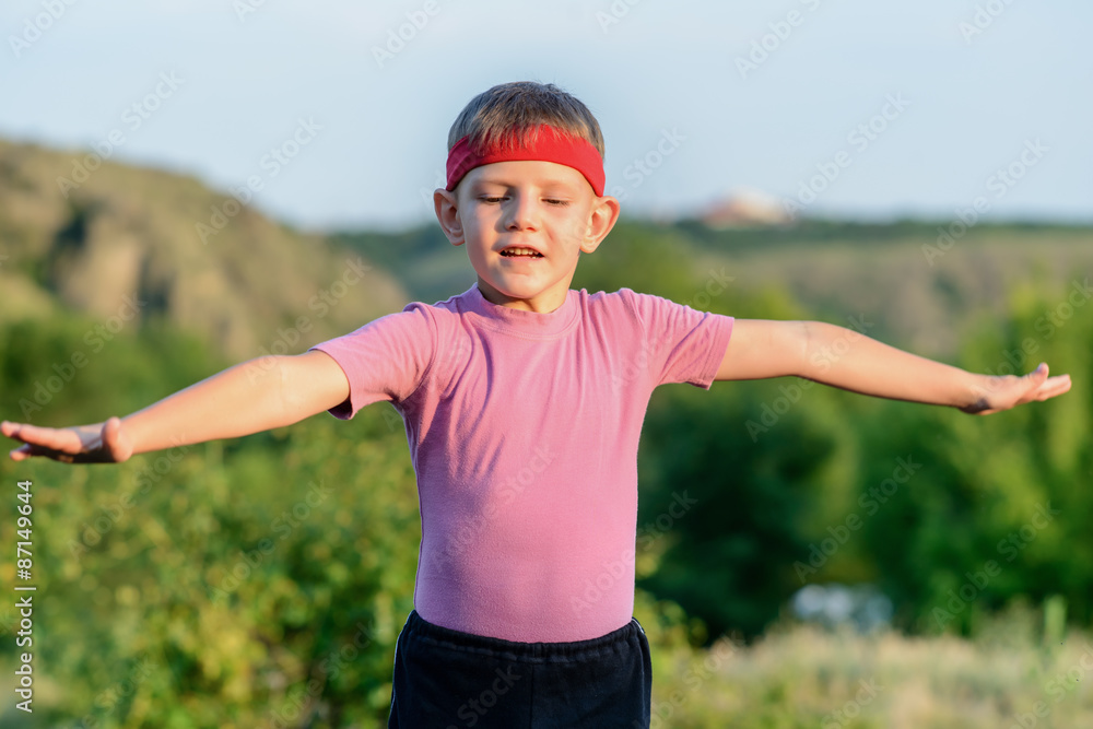 Serious Boy Practicing Martial Arts at the Field Serious Boy Practicing Martial Arts at the Field