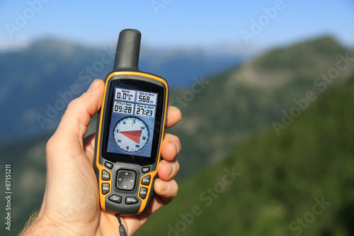 Hand held outdoor GPS being used for navigation in the mountains.