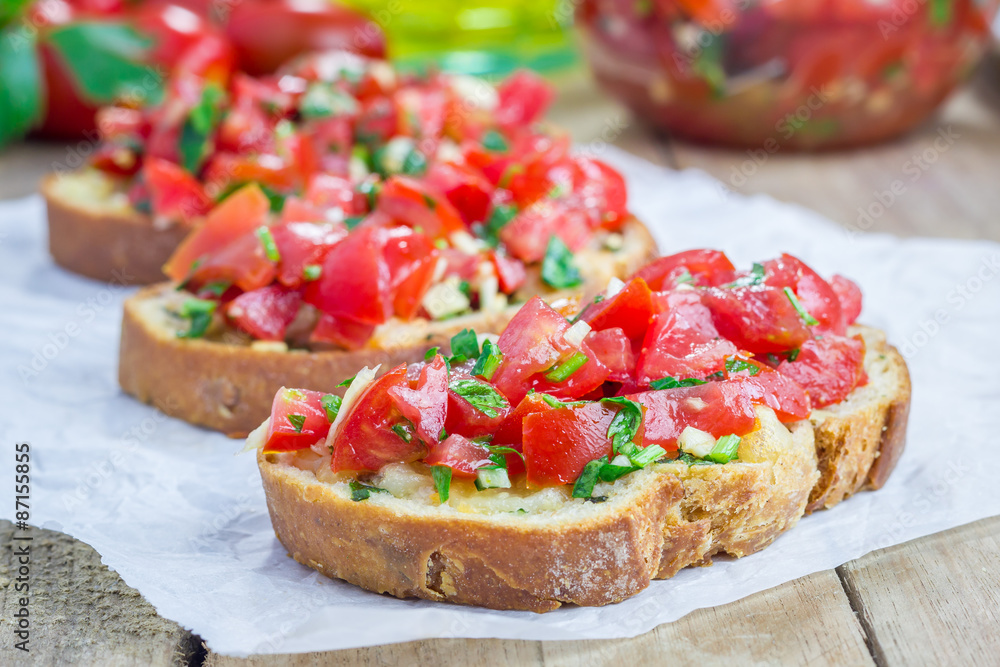 Bruschetta with tomatoes, herbs and oil on toasted garlic cheese bread Bruschetta with tomatoes, herbs and oil on toasted garlic cheese bread