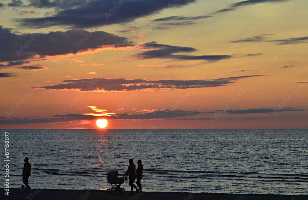 People walking during sunset at sandy beach of the famous Baltic resort of Jurmala city, latvia