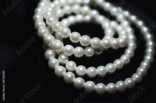 white pearl necklace on black silk