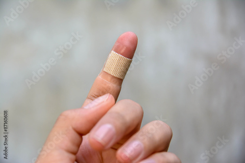 brown medicine bandage on injured finger 