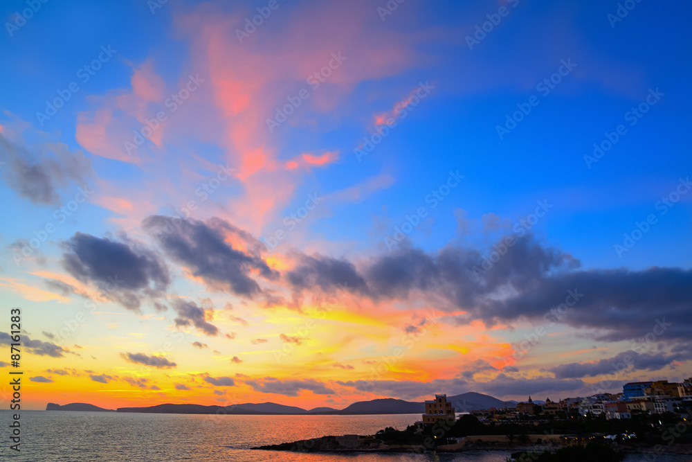 colorful sunset over Alghero shoreline