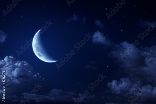 Big moon and stars in a cloudy night blue sky