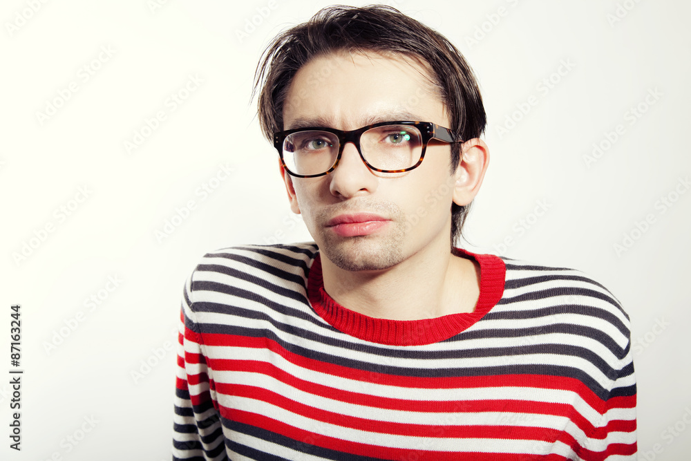 thoughtful young man in glasses ]