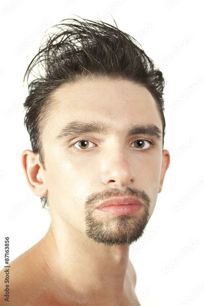 Fototapeta premium Portrait of a young brunette man with a stylish haircut