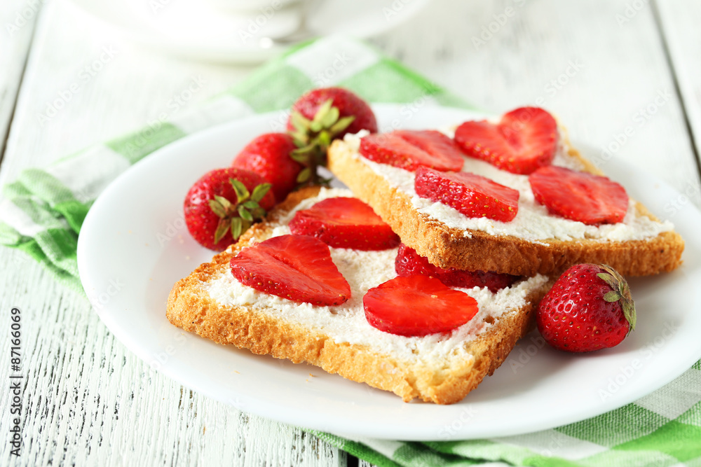 Fresh toast with strawberry on white wooden background Fresh toast with strawberry on white wooden background