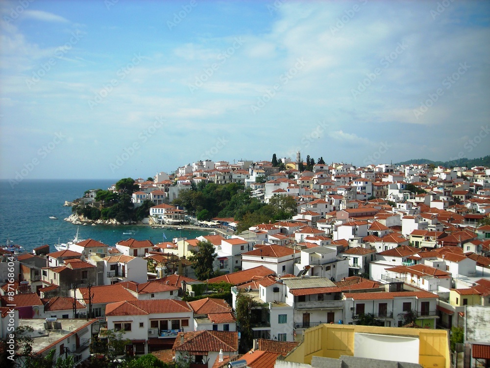Panoramic view on the picturesque town of Skiathos, capital of the Greek island of the same name, which belongs to the Northern Sporades group, on a sunny day.