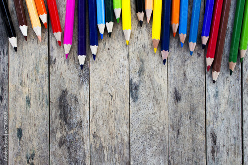 color pencils on wood plank background