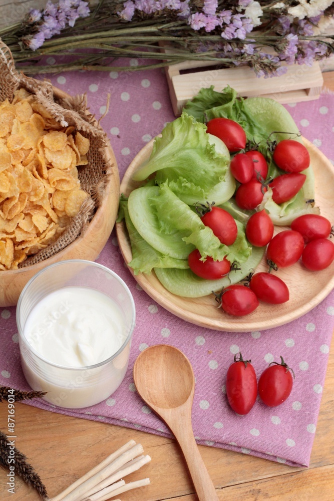 White yogurt and fresh cherry tomatoes with cornflake. White yogurt and fresh cherry tomatoes with cornflake.