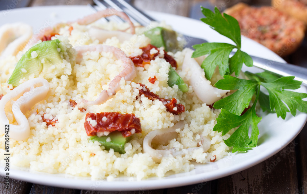 Couscous with seafood, dried tomatoes, avocado and little toast Couscous with seafood, dried tomatoes, avocado and little toast