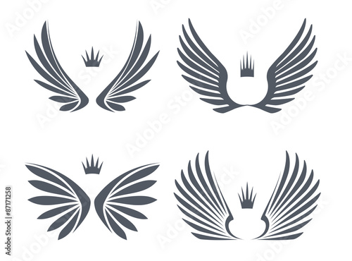 Set of four pairs of wings with crowns. Vector illustration.