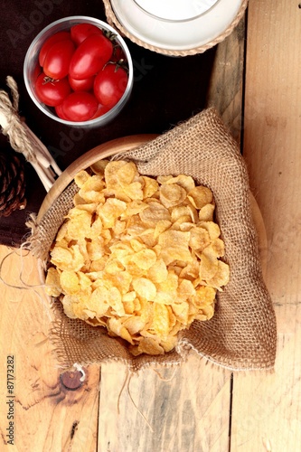 corn flake and milk with fresh cherry tomatoes.