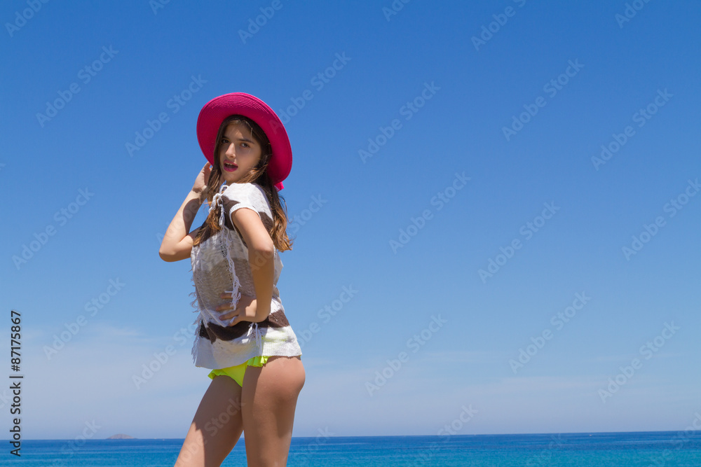 Brunette teen in bikini and beachwear enjoys the summer sun. Brunette teen in bikini and beachwear enjoys the summer sun.