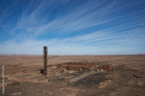 Derelict and rusting industrial buildings at the historic Humberstone Saltpeter Works in the Atacama Desert near Iquique in Chile. The site is now an open air museum and a Unesco World Heritage SIte. photo