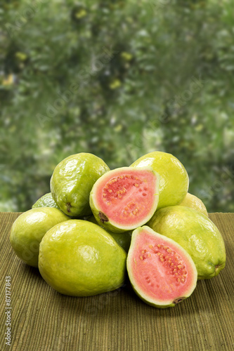 Some brazilian guavas over a striped surface.