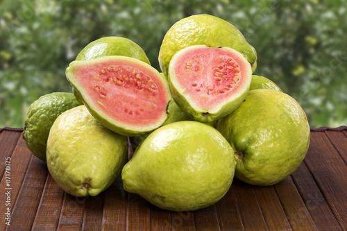 Some brazilian guavas over a striped surface.